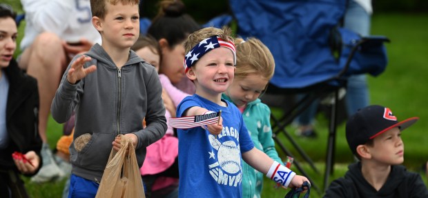 In patriotic clothing, Luke Willmeng, 3, of Park Ridge, in the company of his parent Cindy Willmeng, waves the flag on Cumberland Avenue during the Park Ridge Memorial Day Parade on May 27, 2024 in Park Ridge. (Karie Angell Luc/Pioneer Press)