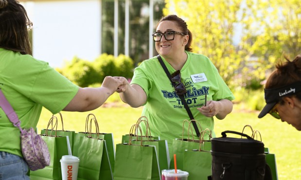 Right, Alisa Martorano, TotalLink to Community's director of development, is at the raffle table before the walk steps off. Taken at the TotalLink Trot in Northbrook on May 19, 2024 at Techny Prairie Park and Fields. (Karie Angell Luc/Pioneer Press)