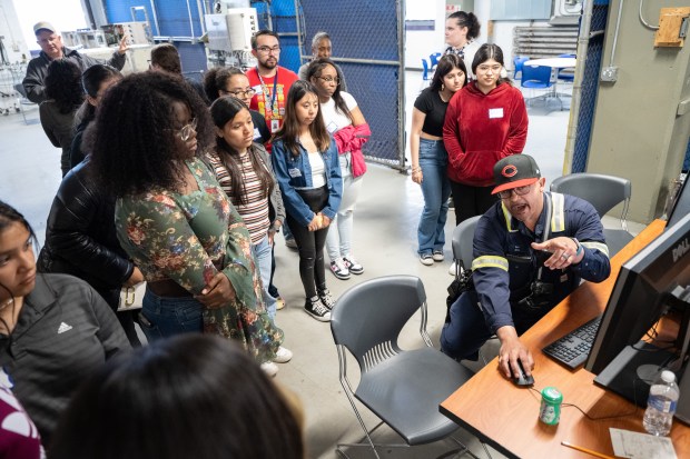 BP Whiting worker Dylan Dudley shows a system status display to East Chicago Central students during a demonstration at Girls in STEM Day at the BP Whiting Refinery on Friday, May 17, 2024. (Kyle Telechan/for the Post-Tribune)