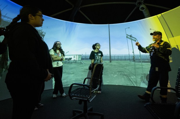 BP Whiting Refinery major mechanical employee Keith Felde, on right, speaks to students from Hammond Central in a projection dome used for simulation and training during a demonstration at Girls in STEM Day at the facility on Friday, May 17, 2024. (Kyle Telechan/for the Post-Tribune)