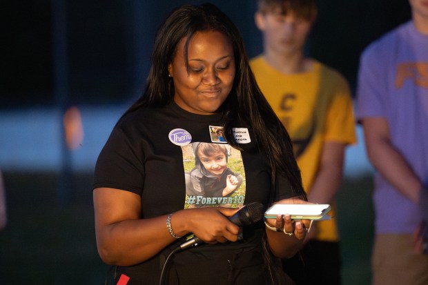 Merrillville resident Aaliyah Stewart, founder of The ASW Foundation, plays a voicemail from Dakota Levi Stevens, 10, who died in foster care earlier this month, during a candlelight vigil for Dakota in Liberty Township on Tuesday, May 7, 2024. (Kyle Telechan/for the Post-Tribune)