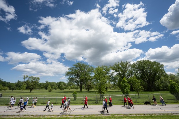 Participants walk the trail around Highland's Wicker Park during the 2nd Annual We Fight Together Drug Poisoning and Overdose Awareness run/walk on Saturday, May 11, 2024. (Kyle Telechan/for the Post-Tribune)