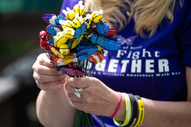 Sounds of Sarah founder Patty Stovall hands out small gifts to other mothers who have lost children to drug overdose during the 2nd Annual We Fight Together Drug Poisoning and Overdose Awareness run/walk on Saturday, May 11, 2024. (Kyle Telechan/for the Post-Tribune)