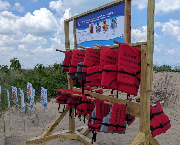 A life jacket loaner rack for Marquette Park beach swimmers in Gary to use and return while they're at the beach is now available near the concession stand. The Friends of Marquette Park's Miller Beach water safety committee dedicated the rack on Saturday, May 18, 2024. (Carole Carlson/for Post-Tribune)