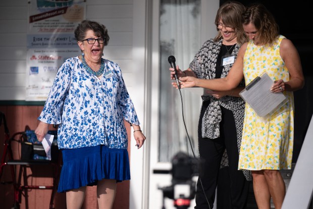 Cedar Lake Historical Association board member LouAnn Miller, on left, reacts after being presented the 2024 Beatrice Horner Cultural Award during a celebration of the opening of the 2024 season at the museum in Cedar Lake on Friday, May 3, 2024. (Kyle Telechan/for the Post-Tribune)