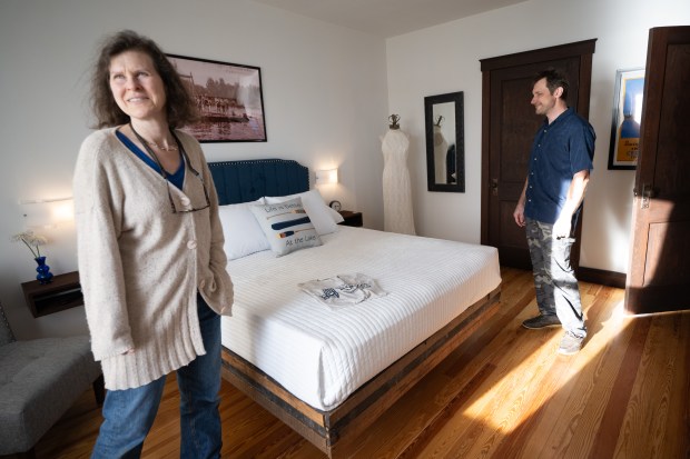 Museum at Lassen's members Mikhail Kostikov and Jessica Renwald take a tour of a model room at the Lassen's Resort during a season opening celebration in Cedar Lake on May 3, 2024. (Kyle Telechan/for the Post-Tribune)