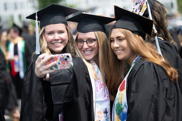 Education graduates, from left, Jillian Jackson, Camille Schafer, and Kelly Minton take a selfie as they line up for the procession during Purdue Northwest's spring commencement ceremony on Saturday, May 4, 2024, in Hammond. (Kyle Telechan/for the Post-Tribune)