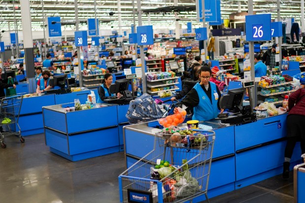 Cashiers process purchases at a Walmart Supercenter in North Bergen, N.J., on Feb. 9, 2023.