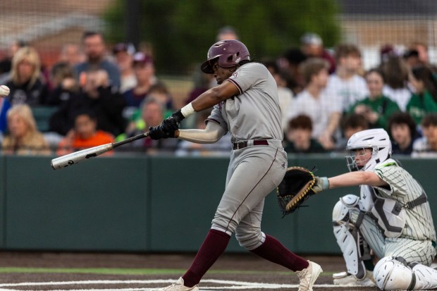 Brother Rice's Treylan Webster hits a solo-home run against Evergreen Park during a nonconference game in Evergreen Park on Friday, May 10, 2024. (Vincent D. Johnson/for the Daily Southtown)