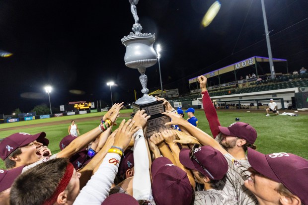 Lockport players hold up the championship trophy after winning the Do It Stevie's Way Tournament championship game against Lyons at Ozinga Field in Crestwood on Saturday, May 18, 2024. (Vincent D. Johnson/for the Daily Southtown)