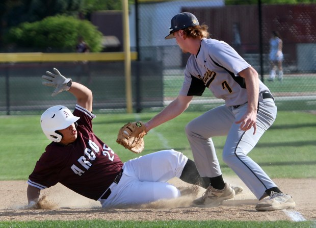 Richards Neil Glynn tries to tag out Argo's Julio Ruiz at first during the baseball game in against Argo in Summit Wednesday, May 1, 2024. (James C. Svehla/for the Daily Southtown)