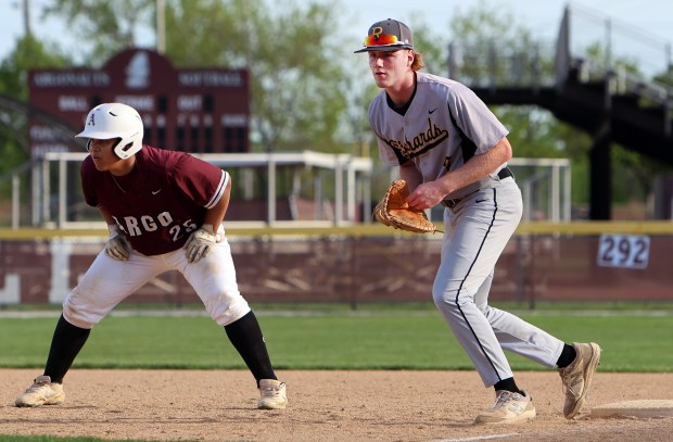 Richards Neil Glynn covers first base as Argo's Julio Ruiz leads off during the baseball game in Summit Wednesday, May 1, 2024. (James C. Svehla/for the Daily Southtown)