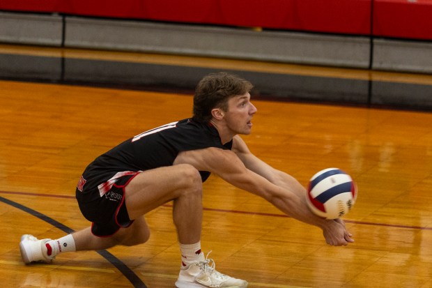 Marist's Luke Brannigan (11) gets low for a dig on a Jones serve during the Marist Sectional final in Chicago on Tuesday, May 28, 2024. (Vincent D. Johnson/for the Daily Southtown)