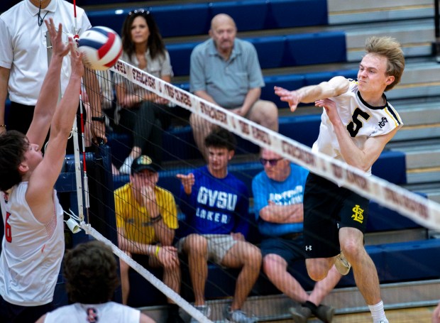 St. Laurence's Roman Rzeszutko (8) hits the ball over the net against the Stagg Chargers during a game in Palos Hills on Tuesday, May 21, 2024. (Nate Swanson/for the Daily Southtown)