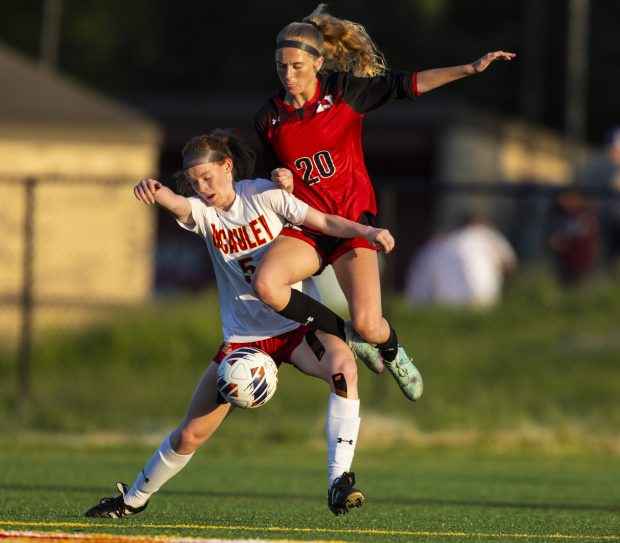 Marist's Mia Sherry (20) gets tangled up with Mother McAuley's Emily Cover (5) while going for the ball during the Class 3A Mother McAuley Regional semifinals in Chicago on Wednesday, May 15, 2024. (Vincent D. Johnson/for the Daily Southtown)