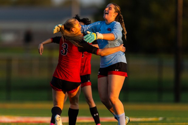 Marist's Cate Meehan is greeted by goalie Caitlin Schofield at midfield after Meehan's goal put the Red Hawks on the board against Mother McAuley during the Class 3A Mother McAuley Regional semifinals in Chicago on Wednesday, May 15, 2024. (Vincent D. Johnson/for the Daily Southtown)