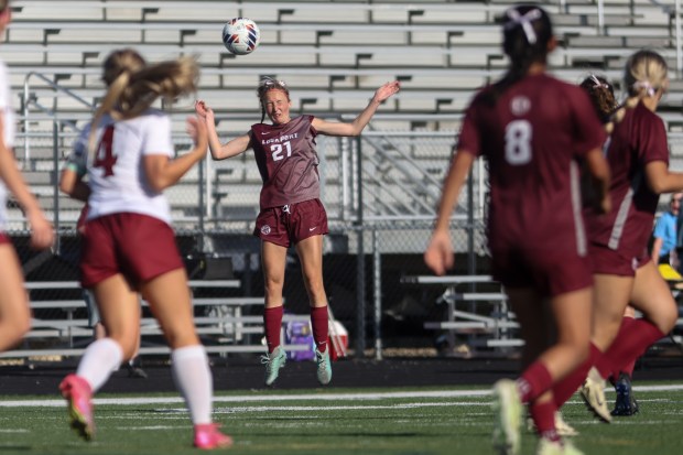 Lockport's Alyssa Flood (21) heads the ball during the Class 3A Plainfield North Sectional semifinal game against Plainfield North in Plainfield on Wednesday, May 22, 2024. (Troy Stolt/for the Daily Southtown)