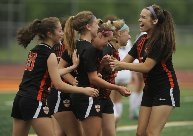 Lincoln-Way West's Emliy Tigchelaar (31) {middle} receives congratulations from teammates after scoring a goal against Sandburg giving the Warriors the early lead during a Southwest Suburban Conference game Wednesday, May 8, 2024 in New Lenox, IL. (Steve Johnston/Daily Southtown)