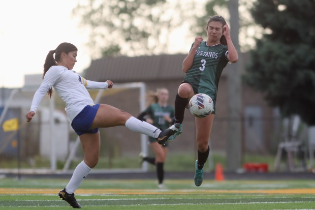 Evergreen Park's Jade Rubalcava (3) competes for the ball with Crete-Monee's Itzel Romo (4) during the Class 2A St. Laurence Regional semifinal game in Burbank on Tuesday May 14, 2024. (Troy Stolt/for the Daily Southtown)