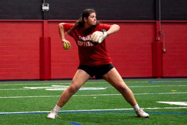 Marist's Gabi Novickas (22) throws the ball from third base while practicing with the Redhawks at Marist SportsPlex in Palos Heights on Thursday, May 9, 2024. (Nate Swanson/for the Daily Southtown)
