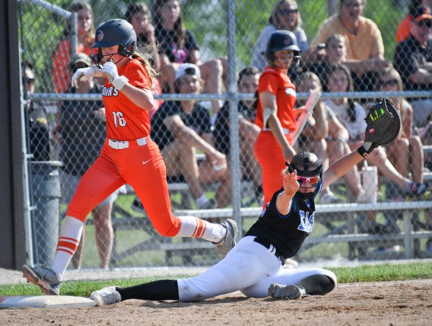 Lincoln-Way West's Kaylea Armstrong (16) is safe at first after Lincoln-Way East first baseman Anie Balta was ruled to not have her foot in contact with the base during the Class 4A Lincoln-Way West Regional final on Thursday, May 23, 2024, in New Lenox.(Jon Cunningham for the Daily Southtown)