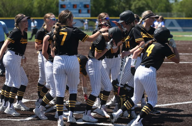 Andrew players gather around home plate as center fielder Kaidence Bruno (5) scores following a two-run homerun during the Class 4A Sandburg Regional at Carl Sandburg High School in Orland Park on Saturday, May 25, 2024. (Trent Sprague/for the Daily Southtown)