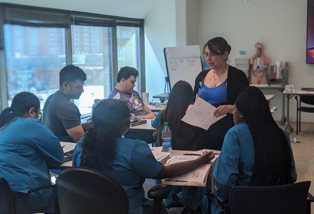 Johanna Hernandez, program coordinator of Clinical Assistant Training Programs at Northwestern Medicine, discusses a lesson during a recent Basic Nursing Assistant Training Program session and Northwestern in Chicago. The program is free for staff members in the Northwestern Medicine system. (Janice Neumann/Daily Southtown)