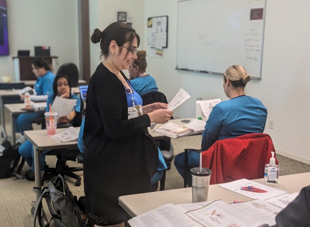 Northwestern Medicine program coordinator Johanna Hernandez discusses a lesson with students during a session of the Basic Nursing Assistant Training Program at Northwestern Hospital in Chicago. Several students work at Northwestern Medicine Palos Hospital in Palos Heights. (Janice Neumann/Daily Southtown)