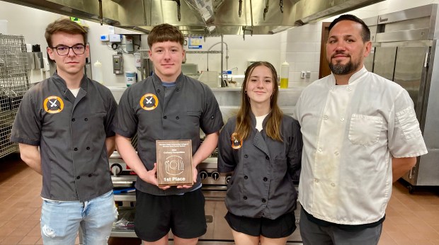 Shepard seniors Jan Jablonski, left, Keith Moser and Karolina Kisielewski with culinary instructor Dan Solski and their first-place trophy. (Steve Metsch/for Daily Southtown)