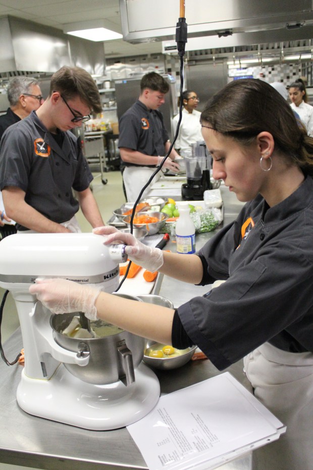 Shepard seniors Karolina Kisielewski, Jan Jablonski and Keith Moser prepare a meal for the culinary competition at Moraine Valley Community College. (High School District 218)