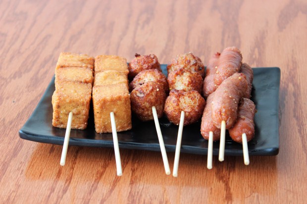 Grilled tofu, cuttlefish balls and pork sausage snacks by Hello Jasmine on May 8, 2019, in the Chinatown area of Chicago.