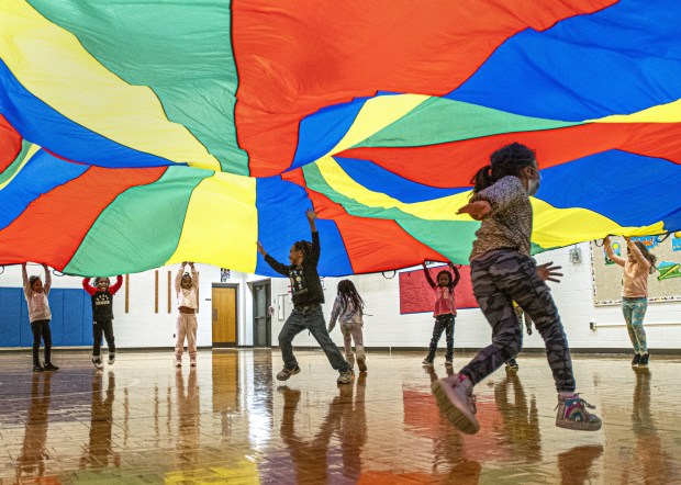 Kindergarteners take part in physical education class using a parachute at Homer Iddings Elementary School in Merrillville, Indiana Tuesday April 19, 2022. (Andy Lavalley for the Post-Tribune)