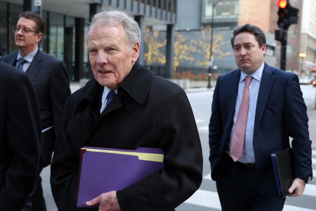 Former Illinois House Speaker Michael Madigan, center, leaves the Dirksen U.S. Courthouse in Chicago on Jan. 3, 2024, after a hearing before U.S. District Judge John Robert Blakey over whether Madigan's landmark trial should be postponed pending a decision from the U.S. Supreme Court in another bribery case. (Terrence Antonio James/Chicago Tribune)