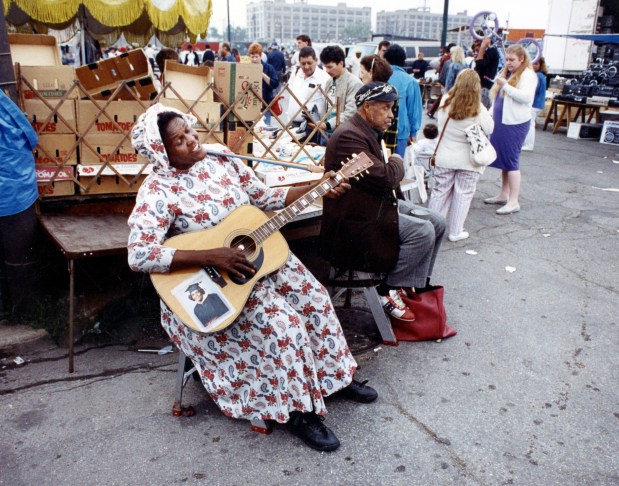 A woman gives a Sunday morning serenade at Maxwell Street and Newberry Avenue in Chicago, circa 1990. (Chicago Tribune historical photo)