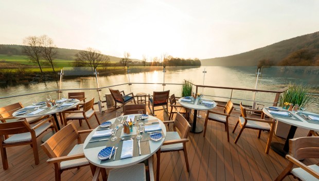 Tables are ready for outdoor dining on the Aquavit deck of a Viking longship. (Viking Cruises)