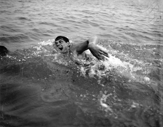 Johnny Weissmuller of the Illinois Athletic Center, at the 1926 River Swim in Chicago. Weissmuller won the annual Illinois Athletic Club Chicago river marathon, covering a little more than three miles, in 56 minutes and 48 seconds. (Chicago Herald and Examiner)