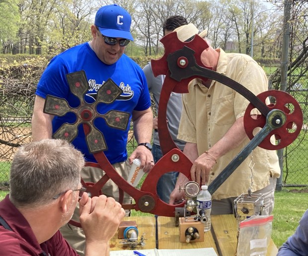 Tim Flynn, right, explains a sculpture he is designing as others look on. (Steve Sadin/Lake County News-Sun)