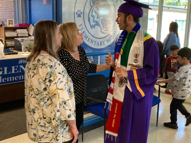 Jordano Campos-Hernandez talks to two former Glenwood Elementary School teachers during Waukegan High School's Return to My Roots parade. (Steve Sadin/Lake County News-Sun)