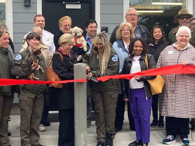 Mayor Ann Taylor and Susan Elliott cut a ribbon to open the new Waukegan Police Animal Control center. (Steve Sadin/Lake County News-Sun)