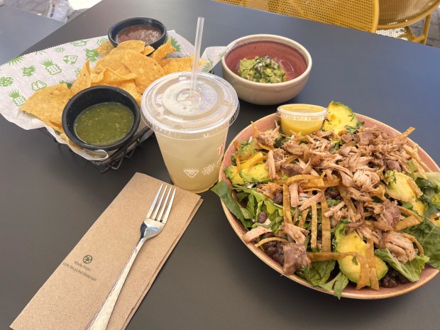 The Tortazo salad with romaine, arugula, avocado, black beans, radishes, poblano rajas, cilantro, tortilla strips, green chile citrus vinaigrette with a carnitas topping at Tortazo at the Old Orchard Shopping Center in Skokie. The restaurant opened its doors on May 25. (Credit: Richard Requena/Pioneer Press)