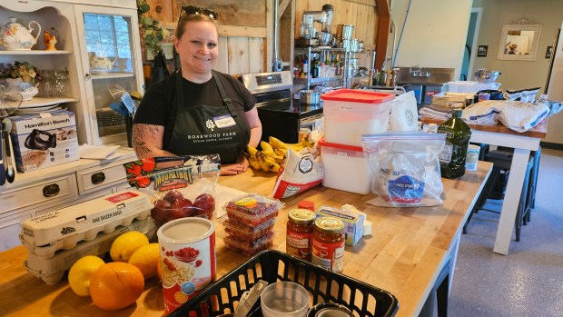 Megan Kelleher of Oswego, who works as a second-grade teacher, is working this summer as a helper at Rosewood Farm in Sugar Grove, where a two-day Baking Camp for kids was held this week. (David Sharos / For The Beacon-News)