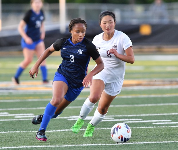 Burlington Central's Mekenzie Rogers (3) moves into position to kick the first goal of the game as Wheaton Academy's Hannah Lindberg defends during the Class 2A Hinsdale South Supersectional game on Tuesday, May 28, 2024, in Darien.(Jon Cunningham/for The Beacon-News)