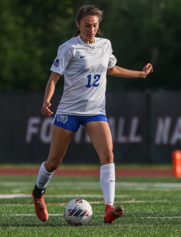 St. Charles North's Kyra Treanor (12) dribbles down field during the Class 3A state semifinal against Fremd in Naperville on Friday, May 31, 2024. (Troy Stolt/for the Aurora Beacon News)