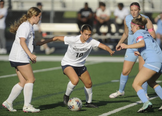 West Aurora's Olivia Del Toro (10) weaves between the Plainfield South defense during a Southwest Prairie Conference game Tuesday, April 30, 2024 in Plainfield, IL. (Steve Johnston/The Beacon-News)