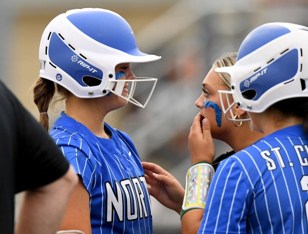 St. Charles North's catcher Skyla Ritter (5), right, helps batter Mackenzie Patterson (7) left, keep her focus as Oswego's team has a long meeting at the mound. St. Charles North defeated Oswego 2-1 in the Class 4A state semifinals at Louisville Slugger Sports Complex in Peoria, Friday, June 7, 2024. (Rob Dicker / Beacon News)