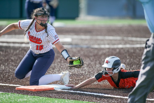 Oswego 1st base #16 Rikka Ludvigson is late with the tag on Minooka #34 Olivia Boyd during the Oswego vs. Minooka, Class 4A Illinois Wesleyan Supersectional in Bloomington IL. June 03, 2024 (Daryl Wilson/for the Chicago Tribune)