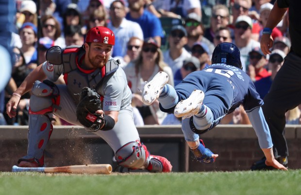 Cubs pinch runner Pete Crow-Armstrong dives toward the plate as Cardinals catcher Pedro Pagés readies for the tag in the eighth inning on June 14, 2024, at Wrigley Field. Crow-Armstrong was ruled out. (John J. Kim/Chicago Tribune)