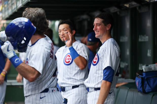 Cubs starter Kyle Hendricks, right, laughs as outfielder Seiya Suzuki, center, goofs around with shortstop Dansby Swanson after Swanson hit a home run in the fourth inning against the Giants on June 19, 2024, at Wrigley Field. (Eileen T. Meslar/Chicago Tribune)