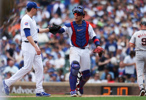 Chicago Cubs catcher Miguel Amaya fist bumps pitcher Kyle Hendricks during the fifth inning against the San Francisco Giants at Wrigley Field on June 19, 2024. (Eileen T. Meslar/Chicago Tribune)