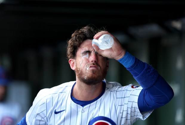 Chicago Cubs outfielder Cody Bellinger (24) pours water on himself to cool off on a hot and humid 95 degree day before the start of a game between the Chicago Cubs and San Francisco Giants at Wrigley Field on June 16, 2024, in Chicago. (Stacey Wescott/Chicago Tribune)